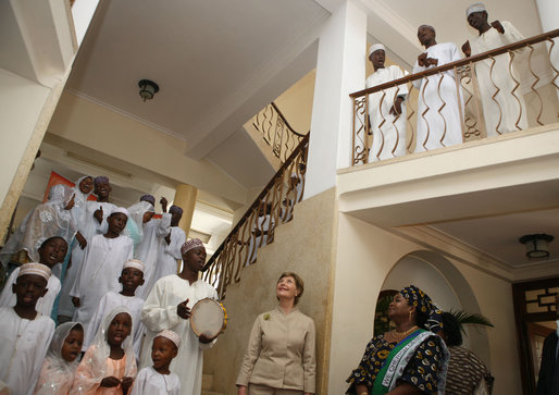Mrs. Laura Bush and Mrs. Salma Kikwete acknowledge the performance of the Madrasa Salima Choir as they depart Karimjee Hall Sunday, Feb. 17, 2008, after participating in a roundtable discussion on HIV/AIDS. White House photo by Shealah Craighead