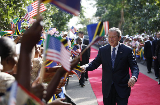 President George W. Bush shakes hands as he greets a large cheering crowd on his arrival Sunday, Feb. 17, 2008, to the State House in Dar es Salaam, Tanzania. White House photo by Eric Draper