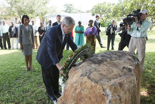 President George W. Bush lays a wreath Sunday, Feb. 17, 2008 in the memorial garden of the U.S. embassy in Dar es Salaam in Tanzania, during a memorial remembrance for those who died in the 1998 U.S. embassy bombing. U.S. Secretary of State Condoleezza Rice stands in background. White House photo by Eric Draper
