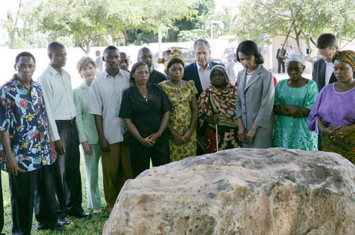 President George W. Bush and Mrs. Laura Bush, joined by U.S. Secretary of State Condoleezza Rice, stand with the family members of victims during a moment of silence Sunday, Feb. 17, 2008 in the memorial garden of the U.S. embassy in Dar es Salaam in Tanzania, in remembrance for those who died in the 1998 U.S. embassy bombing. White House photo by Chris Greenberg