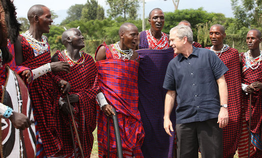 President George W. Bush joins members of a Maasai warrior dance group during their performance to welcome President Bush and Mrs. Laura Bush Monday, Feb. 18, 2008, to the Maasai Girls School in Arusha, Tanzania. White House photo by Eric Draper