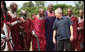 President George W. Bush joins members of a Maasai warrior dance group during their performance to welcome President Bush and Mrs. Laura Bush Monday, Feb. 18, 2008, to the Maasai Girls School in Arusha, Tanzania. White House photo by Eric Draper