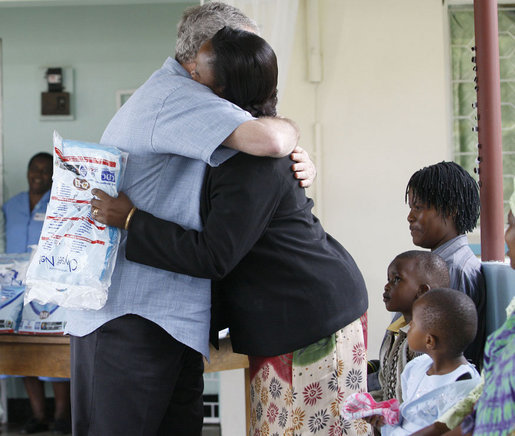 President George W. Bush embraces a pregnant woman after presenting her with a mosquito net during a tour Monday, Feb. 18, 2008, of the Meru District Hospital outpatient clinic in Arusha, Tanzania. The presentation of mosquito nets is part of a program to help in the battle against malaria. White House photo by Eric Draper