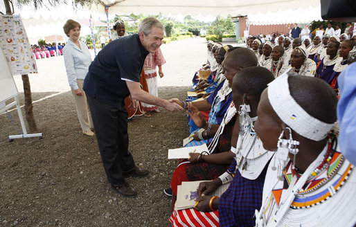 President George W. Bush, joined by Mrs. Laura Bush, greets guests, students and their families during a welcome program Monday, Feb. 18, 2008, to the Maasai Girls School in Arusha, Tanzania. White House photo by Eric Draper