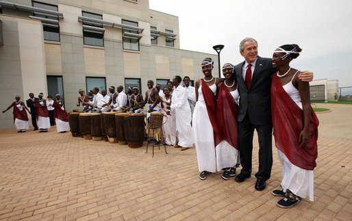 President George W. Bush greets cultural dancers during his visit Tuesday, Feb. 19, 2008, to the dedication and official opening of the new U.S. Embassy in Kigali, Rwanda. White House photo by Eric Draper