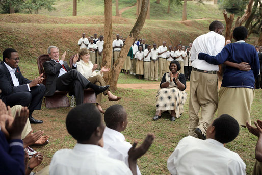 President George W. Bush and Mrs. Laura Bush applaud after a theatrical performance by members of the Lycee de Kigali 'Anti-AIDS Club' Tuesday Feb. 19, 2008, outside of the Lycee de Kigali in Kigali, Rwanda. White House photo by Shealah Craighead