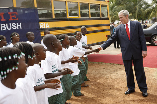 President George W. Bush is greeted by school children Thursday, Feb. 21, 2008, on his arrival to the University of Liberia to attend a education roundtable in Monrovia, Liberia. White House photo by Eric Draper