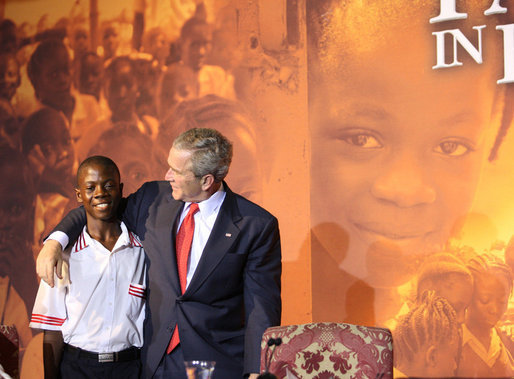 President George W. Bush embraces a student Thursday, Feb. 21, 2008, during an education roundtable at the University of Liberia in Monrovia, Liberia. White House photo by Eric Draper