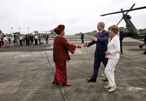 President George W. Bush and Mrs. Laura Bush are greeted by President Ellen Johnson Sirleaf of Liberia Thursday, Feb. 21, 2008, upon their arrival to the Spriggs Payne Airfield in Monrovia, Liberia. White House photo by Eric Draper