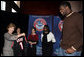 Mrs. Laura Bush holds an National Basketball Association basketball jersey presented to her by NBA player Mr. Greg Oden of the Portland Trail Blazers, during the regional conference on Helping America's Youth at the Portland Center for the Performing Arts in Portland, Ore. Also attending the presentation are, from left, Ms. Robyn Williams, executive director, Portland Center for the Performing Arts; Mrs. Mary Oberst, first lady of Oregon; and student, Ms. Shantel Monk. White House photo by Shealah Craighead