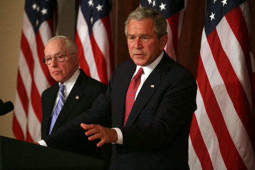 President George W. Bush stands with Attorney General Michael Mukasey as he addresses the National Association of Attorneys General at a drop-by briefing Monday, March 3, 2008, in the Eisenhower Executive Office Building. White House photo by Joyce N. Boghosian