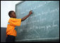 A student at the IDEJEN educational program reads from a chalkboard Thursday March, 13, 2008, during Mrs. Laura Bush's visit to the program at the College de St. Martin Tours in Port-au-Prince, Haiti. White House photo by Shealah Craighead