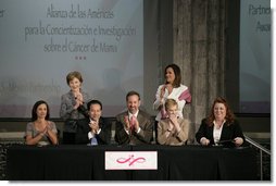 Mrs. Laura Bush applauds following the signing of the U.S.-Mexico Partnership for Breast Cancer Awareness and Research agreement between the Susan G. Komen for the Cure, MD Anderson Cancer Center, U.S. State Department, the Instituto Nacional de Cancerologia and Mexican Association Against Breast Cancer (Fundacion Cim*ab) Friday, March 14, 2008, at the Interactive Economics Museum in Mexico City. From left are Bertha Aguilar, Dr. Alejandro Mohar, U.S Ambassador to Mexico Antonio O. Garza, Jr., Hala Moddelmog, Margarita Zavala (standing), and Dr. Kendra Woods. White House photo by Shealah Craighead