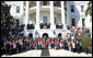President George W. Bush joins the children and parents of the Children's Miracle Network Champion Children for a photo on the South Portico of the White House, Monday, March 17, 2008. White House photo by Shealah Craighead