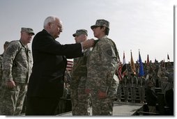 Vice President Dick Cheney awards PFC Veronica Alfaro with the Bronze Star Tuesday, March 18, 2008, during a rally for U.S. troops at Balad Air Base, Iraq. "I can't describe the feeling I had when he awarded me the Bronze Star," said Alfaro, 2nd Platoon senior medic, Bravo Company. "It is definitely a moment I will always remember and cherish; I will never forget it."  White House photo by David Bohrer