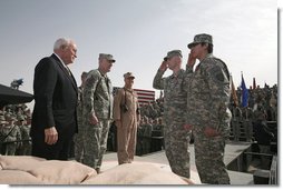 Staff Sgt. Shane Lindsey, second right, and PFC Veronica Alfaro, far right, salute Vice President Dick Cheney after being awarded the Bronze Star Tuesday, March 18, 2008, during a rally for U.S. troops at Balad Air Base, Iraq.  White House photo by David Bohrer