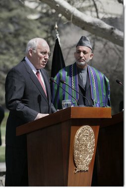With President Hamid Karzai of Afghanistan looking on, Vice President Dick Cheney delivers a statement to the press Thursday, March 20, 2008 on the grounds of Gul Khana Palace in Kabul. "During the last six years, the people of Afghanistan have made a bold and confident journey, throwing off the burden of tyranny, winning your freedom and reclaiming your future," said the Vice President, adding, "The United States of America has proudly walked with you on this journey, and we walk with you still."  White House photo by David Bohrer