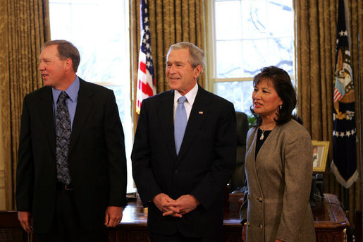 President George W. Bush speaks to reporters with Alton Jones, 2008 Bassmaster Classic Champion, and Judy Wong, 2008 Women's Bassmaster Tour Champion Tuesday, Mar. 25, 2008, in the Oval Office at the White House. White House photo by Joyce N. Boghosian
