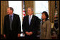 President George W. Bush speaks to reporters with Alton Jones, 2008 Bassmaster Classic Champion, and Judy Wong, 2008 Women's Bassmaster Tour Champion Tuesday, Mar. 25, 2008, in the Oval Office at the White House. White House photo by Joyce N. Boghosian