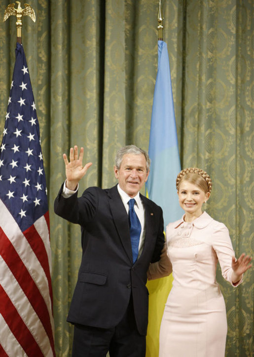 President George W. Bush and Ukraine Prime Minister Yuliya Tymoshenko wave to the media following their meeting Tuesday, April 1, 2008, at Kyiv's Club of Cabinet Ministers. White House photo by Eric Draper