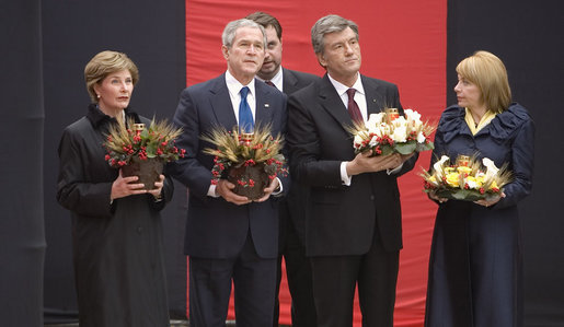 Carrying bowls of corn with candles, President George W. Bush and Mrs. Laura Bush and Ukraine President Viktor Yushchenko and Mrs. Kateryna Yushchenko visit the Holomodor Memorial in Kyiv Tuesday, April 1, 2008. The memorial honors victims of Ukraine's great famine of 1932. White House photo by Eric Draper