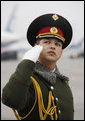 A member of the honor guard salutes as President George W. Bush and Mrs. Laura Bush prepare to depart Kyiv's Boryspil State International Airport Tuesday, April 1, 2008, after spending a daylong visit in Ukraine before continuing on to Bucharest, site of the 2008 NATO Summit. White House photo by Eric Draper