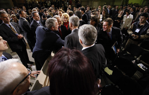 President George W. Bush reaches out to members of the audience Tuesday, April 2, 2008, after he delivered a keynote speech in Bucharest hours before the opening of the two-day NATO Summit. White House photo by Eric Draper