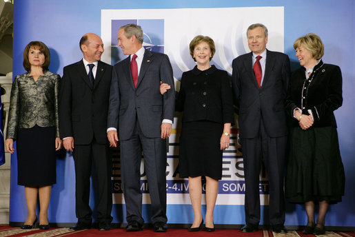 President George W. Bush and Mrs. Laura Bush share a light moment Wednesday, April 2, 2008, with Romania’s President Traian Basescu and Mrs. Maria Basescu, left, and NATO Secretary General Jaap de Hoop Scheffer and Mrs. Jeannine de Hoop Scheffer during the NATO Summit official greeting at the Cotroceni Palace in Bucharest. White House photo by Chris Greenberg