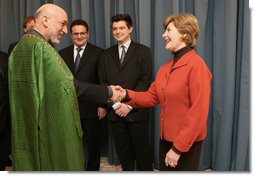 Mrs. Laura Bush greets Afghanistan President Hamid Karzai at the Headquarters of the Romanian Intelligence Service Thursday, April 3, 2008, where they participated in the Young Atlanticist Summit Video Conference with Kabul University.  White House photo by Shealah Craighead