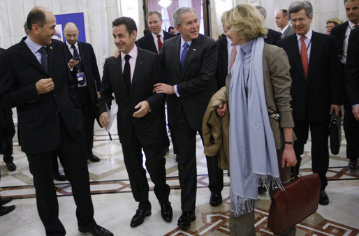 President George W. Bush embraces President Nicolas Sarkozy of France, as they arrive for a session of the NATO Summit Thursday, April 3, 2008, in Bucharest. White House photo by Eric Draper