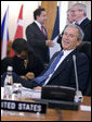 President George W. Bush smiles at photographers as they gather in front of him Friday, April 4, 2008, during the afternoon session of the 2008 NATO Summit in Bucharest. White House photo by Eric Draper