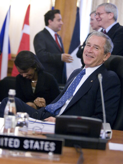 President George W. Bush smiles at photographers as they gather in front of him Friday, April 4, 2008, during the afternoon session of the 2008 NATO Summit in Bucharest. White House photo by Eric Draper