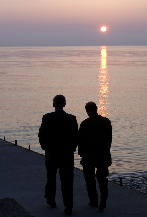 President George W. Bush and Russia's President Vladimir Putin take a sunset walk on a pier along the Black Sea during a visit by President and Mrs. Bush Saturday, April 5, 2008, to President Putin's summer retreat, Bocharov Ruchey, in Sochi, Russia. White House photo by Eric Draper