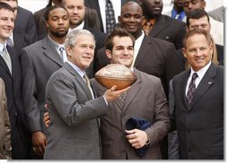 Louisiana State University Tigers' running back Jacob Hester stands next to President George W. Bush after presenting him with a football during a visit to the White House Monday, April 7, 2008, by the 2007 NCAA Football Champions. White House photo by Eric Draper