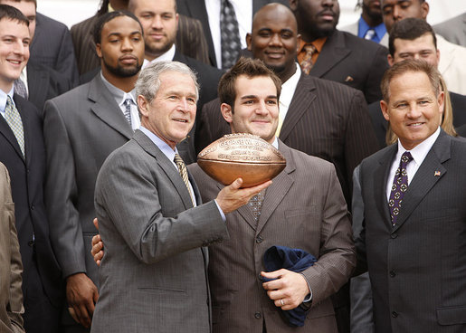 Louisiana State University Tigers' running back Jacob Hester stands next to President George W. Bush after presenting him with a football during a visit to the White House Monday, April 7, 2008, by the 2007 NCAA Football Champions. White House photo by Eric Draper