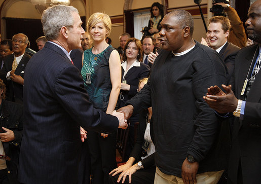 President George W. Bush reaches out to Thomas Boyd Wednesday, April 9, 2008, after signing HR 1593, the Second Chance Act of 2007. Mr. Boyd spent more than 20 years in and out of the prison system until he took his daughter's advice and enrolled in the Jericho program in Baltimore. His success in the re-entry program was noted during the President's remarks when he said, "He's working, back with his family; he's a good guy. And I want to thank you for coming, Thomas." White House photo by Eric Draper