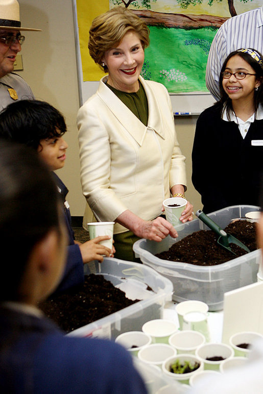 Mrs. Laura Bush joins students from the Williams Preparatory School in Dallas, Thursday, April 10, 2008, during a seed planting demonstration at the First Bloom program to help encourage youth to get involved with conserving America's National Parks. The First Bloom program is being introduced in five cities across the nation to give children a sense of pride in our natural resources and to be good stewarts of America's diverse environment. White House photo by Shealah Craighead
