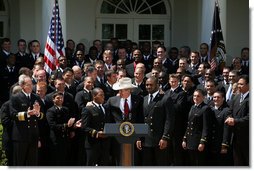 President George W. Bush joins the United States Naval Academy Football Team Monday, April 14, 2008, following the presentation of the Commander-in-Chief's Trophy to the The Naval Academy Midshipmen in the Rose Garden of the White House. White House photo by Joyce N. Boghosian