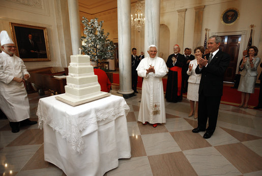 President George W. Bush and Mrs. Laura Bush lead the celebration of the 81st birthday of Pope Benedict XVI as he's presented a cake by White House Pastry Chef Bill Yosses Wednesday, April 16, 2008, at the White House. White House photo by Eric Draper