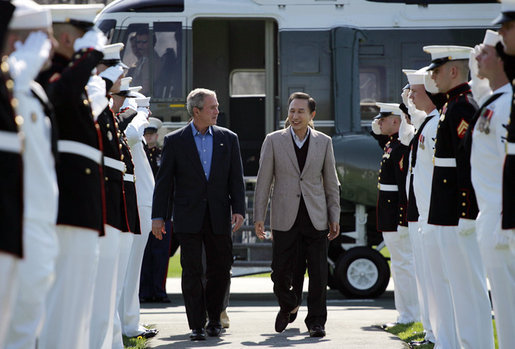 President George W. Bush walks with South Korean President Lee Myung-bak as an honor guard salutes on his arrival Friday, April 18, 2008, at the Presidential retreat at Camp David, Md. White House photo by Shealah Craighead