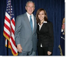 President George W. Bush stands backstage with Yadira Vieyra, a Georgetown University student, who was among those in attendance Thursday, April 24, 2008, at the White House Summit on Inner-City Children and Faith-Based Schools. The President mentioned Yadira in his remarks to the summit, saying: ".Let me end with a story here about Yadira Vieyra. Yadira says she goes to Georgetown University, and she said -- I was asking if Yadira was going to be here so I could ask her to stand here in a minute, and a fellow told me she's a little worried about missing class. So whoever Yadira's teacher is, please blame it on me, not her."  White House photo by Chris Greenberg