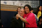 President George W. Bush is embraced by Boys and Girls Club member Melodie Williams as they pose for a photo Friday, April 25, 2008, during the President's visit to the Northwest Boys & Girls Club in Hartford, Conn., where the Boys & Girls members were learning about the cause and prevention of malaria. White House photo by Chris Greenberg