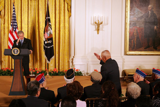 President George W. Bush salutes Tech Sgt. Ben Kuroki, of the 442nd Regiment, during his remarks Thursday, May 1, 2008, at the Celebration of Asian Pacific American Heritage Month in the East Room of the White House. Ben Kuroki, flew nearly 60 combat missions in both Europe and the Pacific. The 442nd Regimental Combat Team was a segregated Army unit composed mostly of Japanese American volunteers. They served with distinction in eight battle campaigns in Europe, and the 442nd was one of the most highly decorated units in World War II. White House photo by Joyce N. Boghosian
