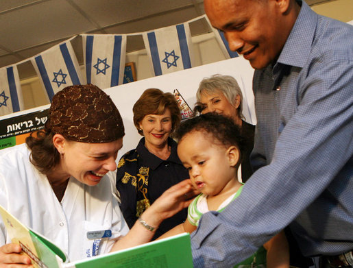 Mrs. Laura Bush looks on during an examination of 1-year-old Orie Holkan during a visit Wednesday, May 14, 2008, to the Tipat Chalav-Gonenim Neighborhood Mother and Child Care Center in Jerusalem. With them are Ms. Sarit Fuast, the nurse, and Talala Holkan, the young child’s father. White House photo by Shealah Craighead