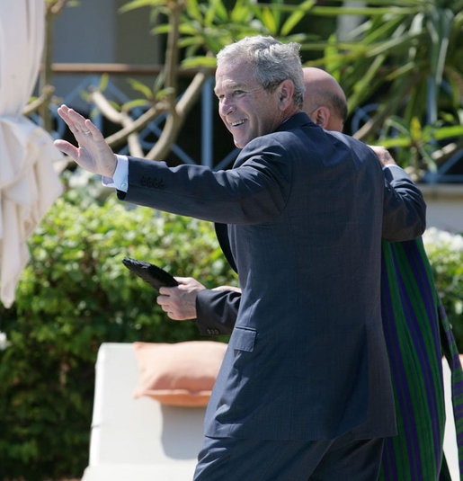 President George W. Bush waves as he walks with Afghanistan President Hamid Karzai Saturday, May 17, 2008, following their meeting with members of the media in Sharm el Sheikh, Egypt. White House photo by Chris Greenberg