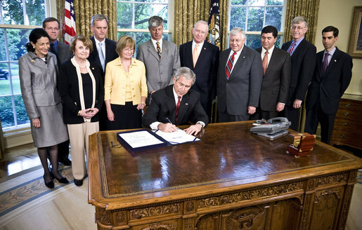 President George W. Bush signs H.R. 493, the Genetic Information Nondiscrimination Act of 2008, Wednesday, May 21, 2008, in the Oval Office. The Genetic Information Nondiscrimination Act would prevent health insurers from canceling, denying, refusing to renew, or changing the terms or premiums of coverage based solely on a genetic predisposition toward a specific disease. The legislation also bars employers from using individuals’ genetic information when making hiring, firing, promotion, and other employment-related decisions. White House photo by Eric Draper