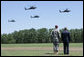 President George W. Bush, joined by Maj. Gen. David Rodriguez, watches a formation of helicopters fly pass during a troop review ceremony Thursday, May 22, 2008, during the President's visit to Fort Bragg, N.C. White House photo by Chris Greenberg