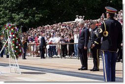 Pausing for a moment of silence, President George W. Bush is accompanied by Major General Richard J. Rowe Jr., commander of the Military District of Washington, right, after laying a wreath at the Tomb of the Unknowns Monday, May 26, 2008, during a Memorial Day ceremony at Arlington National Cemetery in Arlington, VA. White House photo by Chris Greenberg