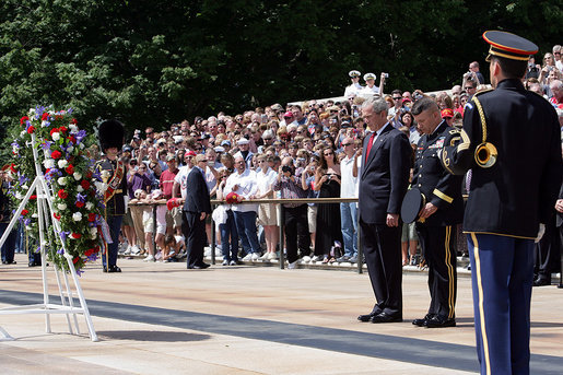 Pausing for a moment of silence, President George W. Bush is accompanied by Major General Richard J. Rowe Jr., commander of the Military District of Washington, right, after laying a wreath at the Tomb of the Unknowns Monday, May 26, 2008, during a Memorial Day ceremony at Arlington National Cemetery in Arlington, VA. White House photo by Chris Greenberg