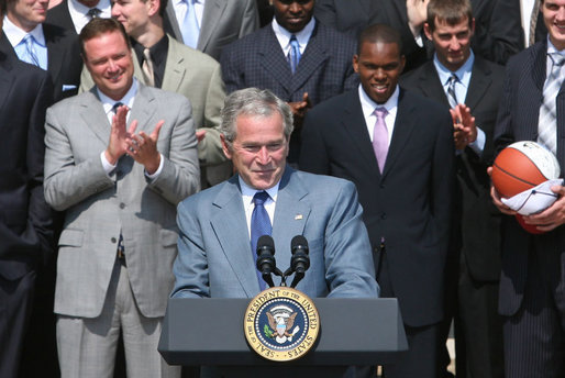 President George W. Bush acknowledges the applause as he greets the University of Kansas Jayhawks Tuesday, June 3, 2008, to the Rose Garden. President Bush told the 2008 NCAA Men's Basketball champs, "I want to congratulate this team. You brought new glory to one of our nation's most storied basketball programs, and you gave your fans all across America one more reason to chant: Rock Chalk, Jayhawk!" White House photo by Joyce N. Boghosian